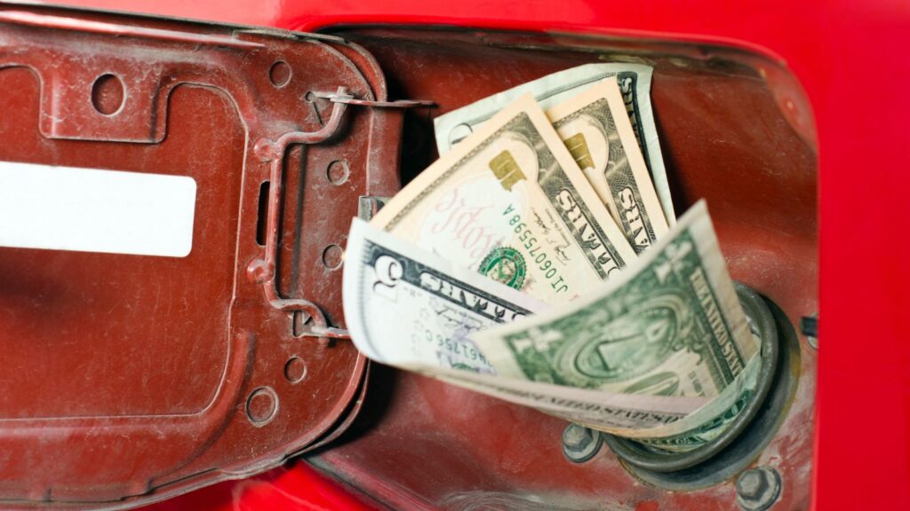 Money sticking out of car gas tank