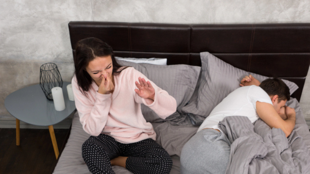 woman covering her nose due to the musty odor of the room