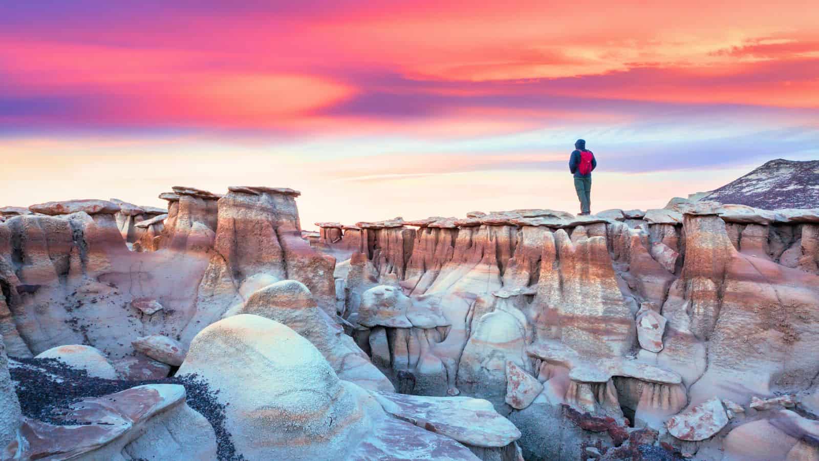 New Mexico, Bisti Badlands Hiker in sunset on rock formations