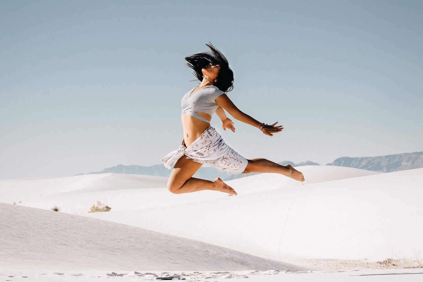 White Sands National Park portrait cat xu jumping in the white sand dunes in the day time