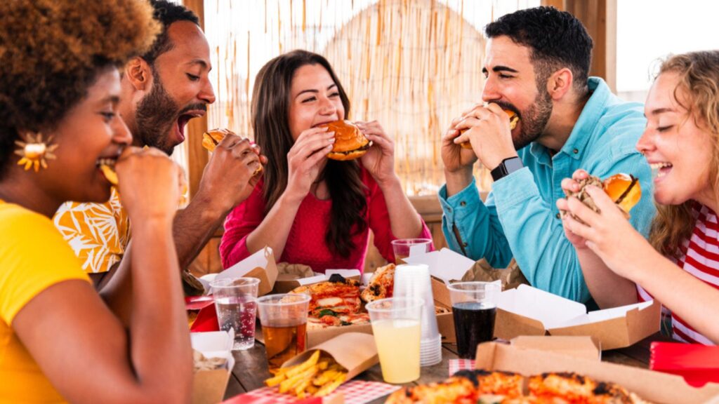 friends eating pizza and burgers