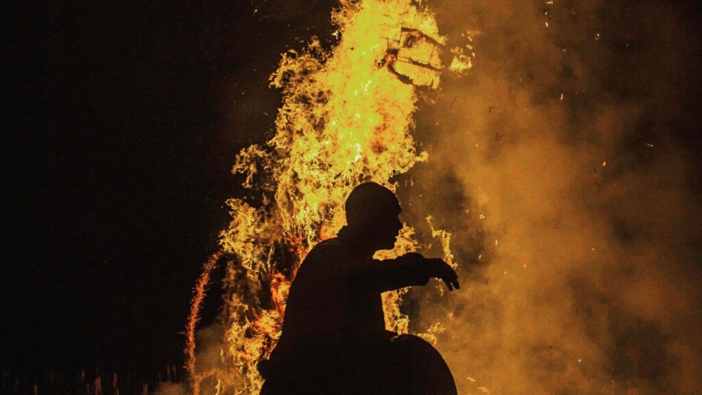 charman silhouette in front of the fire