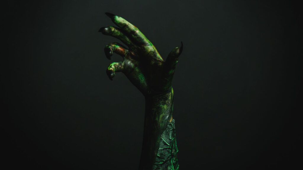 close up hand of green clawed beast