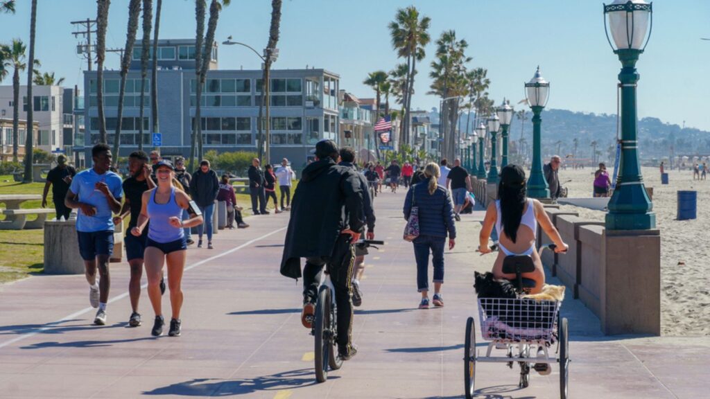 People walking on Mission Beach boardwalk in San Diego, California