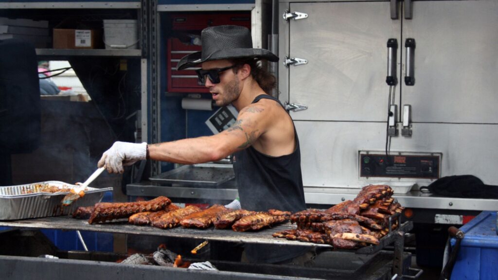 Chef BBQ meat at the on the grill