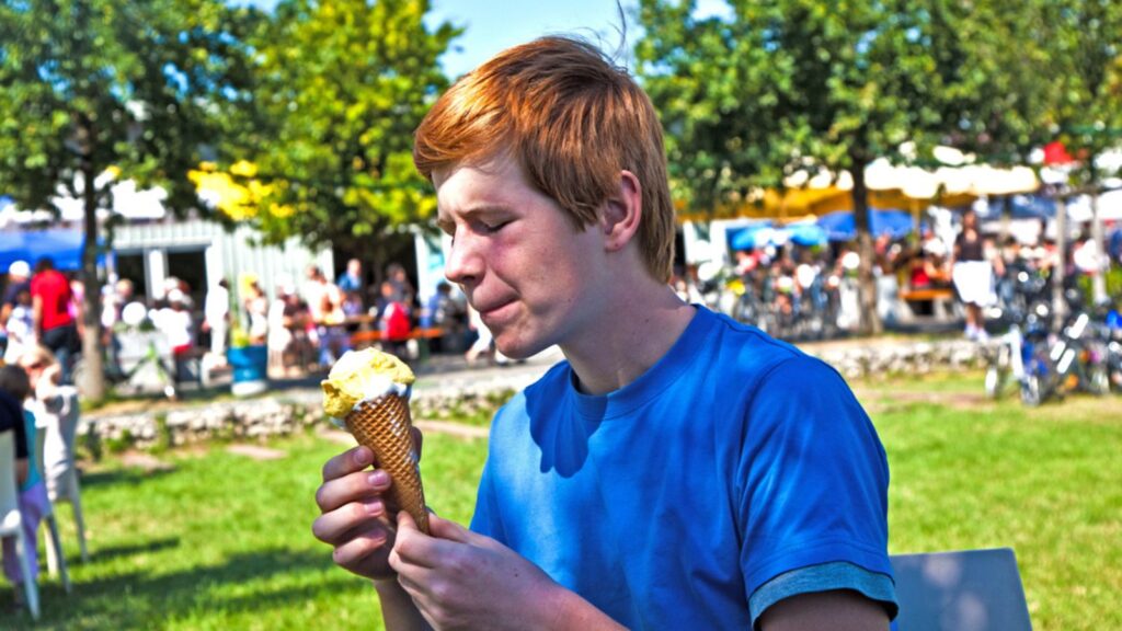 Man licking an ice cream cone