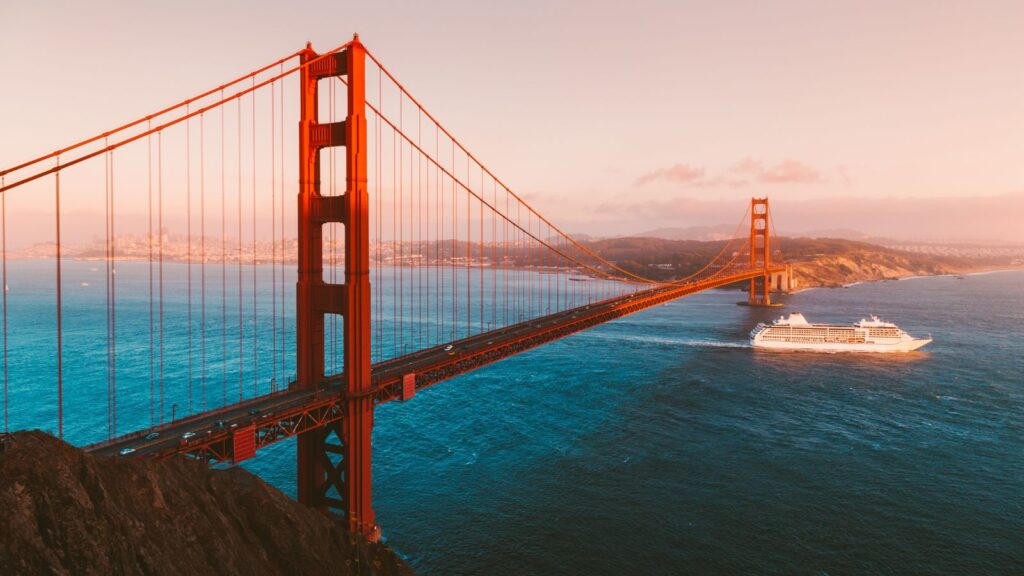 Golden Gate Bridge with cruise ship at sunset, San Francisco, California