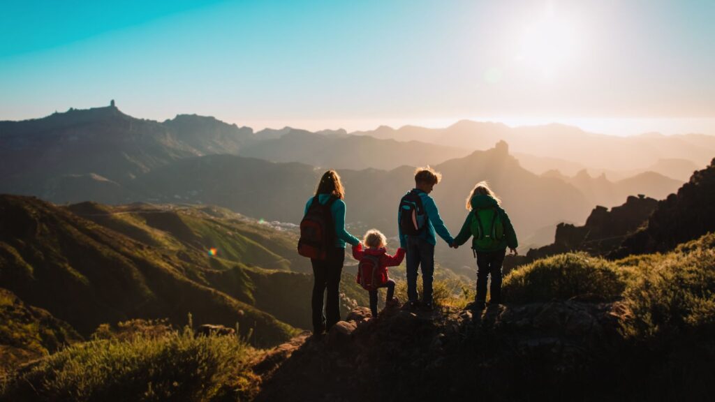 Mother with kids travel in mountains, family hiking