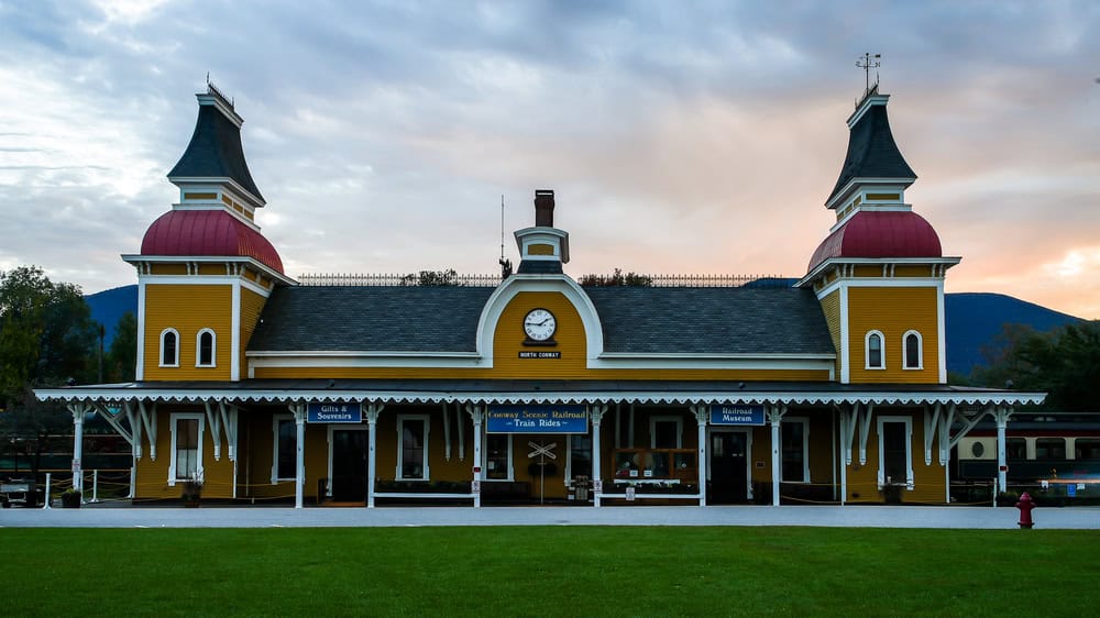 NORTH CONWAY, NEW Conway Scenic Railroad train station building with evening sky colored with sunset