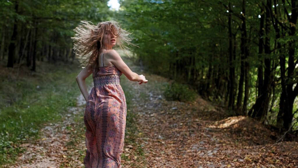 Scared Girl Running through Forest