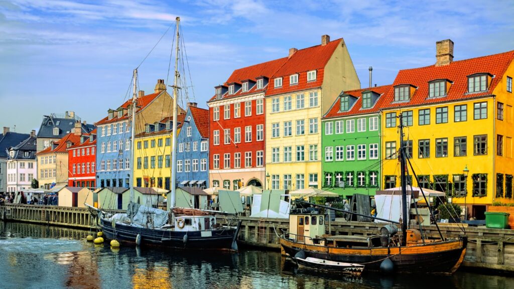 Denmark, Colorful waterfront buildings and ships along the historic Nyhavn canal with reflections