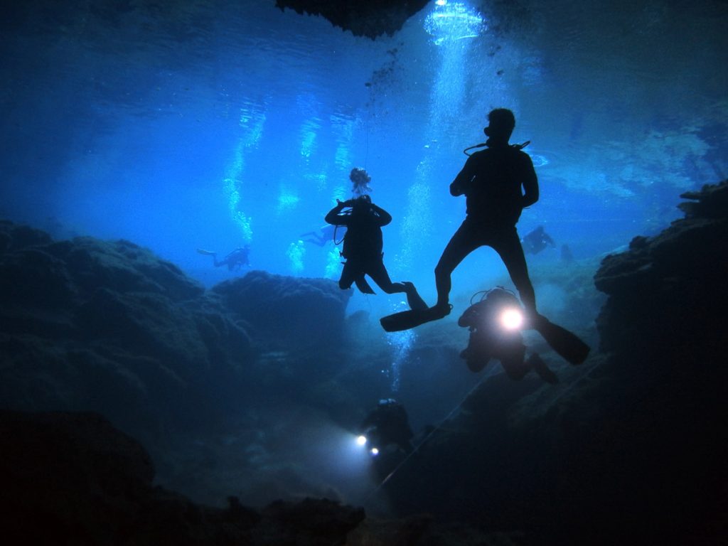 Mexico divers in cenote in Yucatan