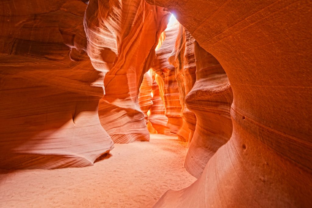 Antelope Canyon view with light rays on sand floor