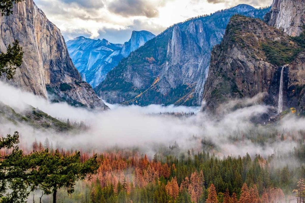 Yosemite National Park Valley at cloudy autumn morning from Tunnel View. Low clouds lay in the valley. California, USA.