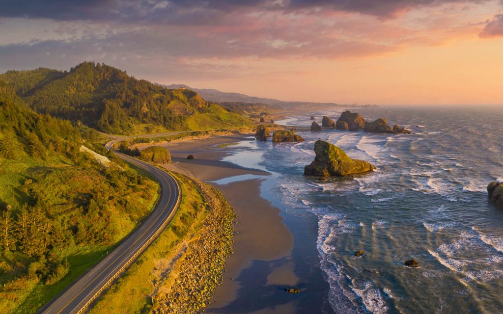 Pacific Highway 101 along the Southern Oregon Coast at Meyer's Creek, aerial drone image with beautiful sunset.