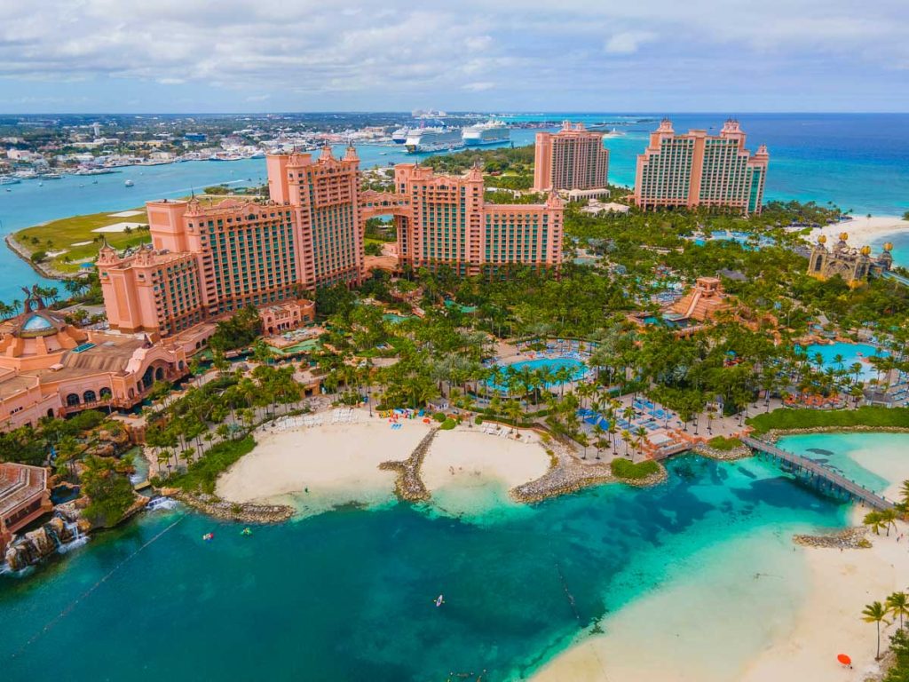 The Bahamas, Paradise Island, Atlantis Resort with iconic coral-colored towers, turquoise lagoons, lazy rivers, and white-sand beaches overlooking Nassau Harbor