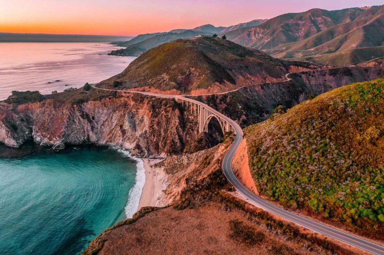 Bixby Bridge on Highway 1 and Big Sur along Pacific Ocean coast, beautiful landscape and aerial view, sunset, sunrise, fog. Concept, travel, vacation, weekend.
