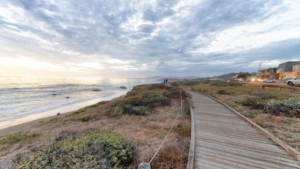 Cambria wooden walkway along the sea at sunset, California