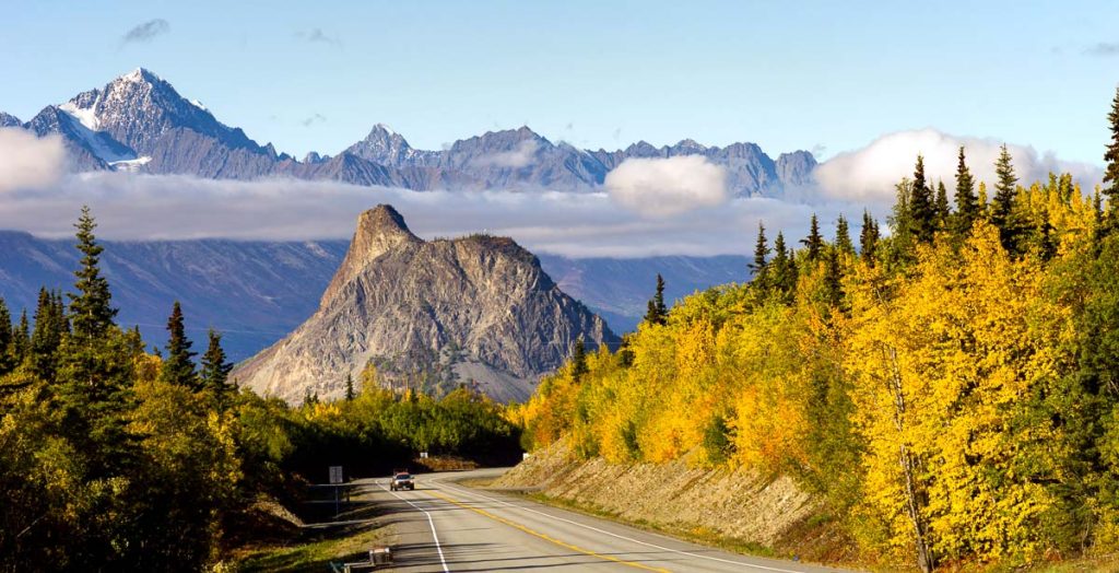 Mountains in the Chugach Range stand above the clouds rising from the Valley in Alaska North America