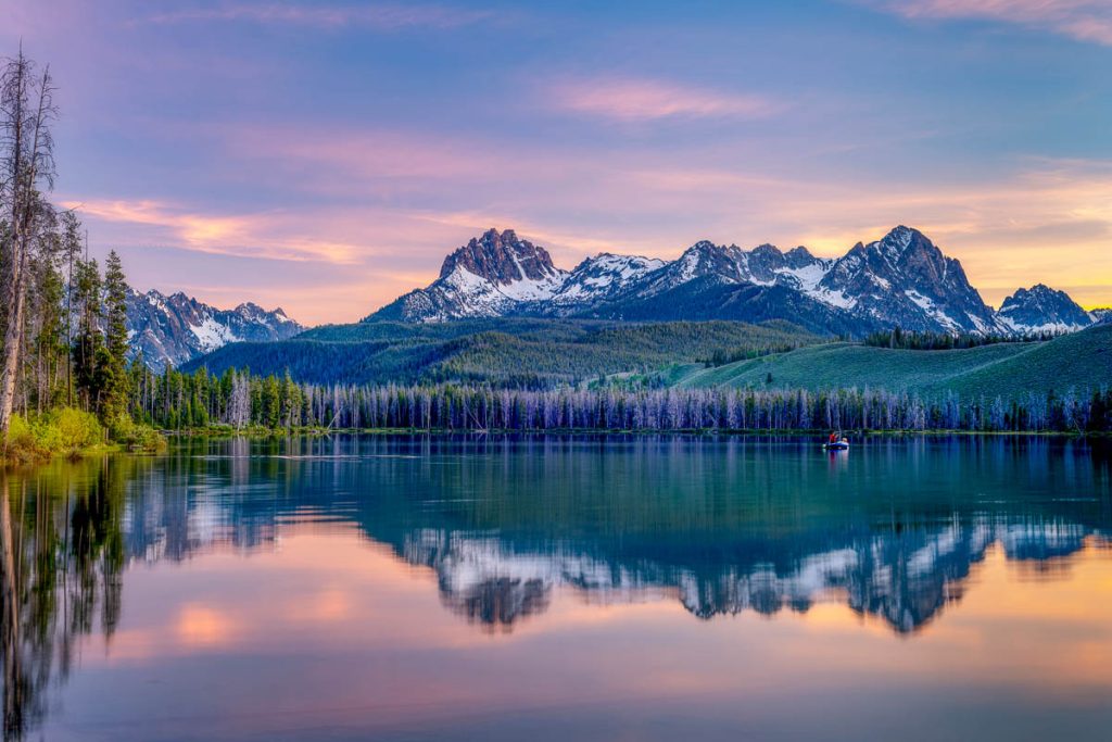 Idaho, Fishing boat in Little Redfish Lake at sunset