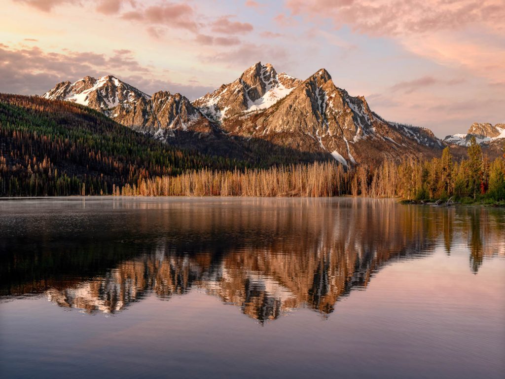Sawtooth mountains bathed in warm sunrise light