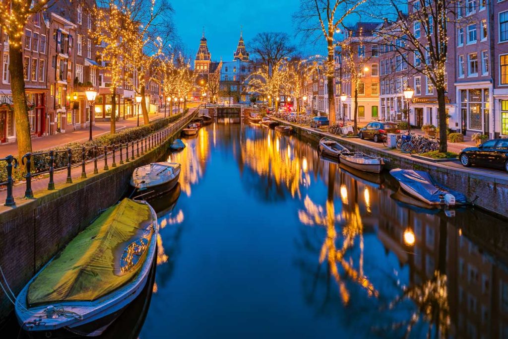 Amsterdam Netherlands canals with Christmas lights during December, canal historical center of Amsterdam at night. Europe