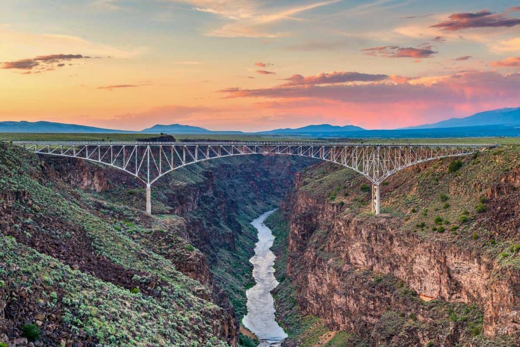Taos, New Mexico, USA at Rio Grande Gorge Bridge over the Rio Grande at dusk.