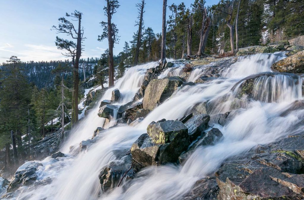 Sunrise at Emerald Bay on Lake Tahoe from the top of Lower Eagle Falls. Torrent of water from snow melt flows into the lake from Sierra Nevada Mountains