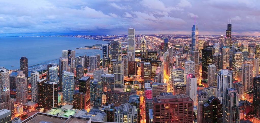 Chicago, Illinois skyline illuminated at dusk along the shores of Lake Michigan