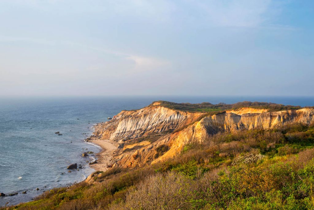 The famous gay head cliffs in Aquinnah Massachusetts as the sun sets on Martha's Vineyard.
