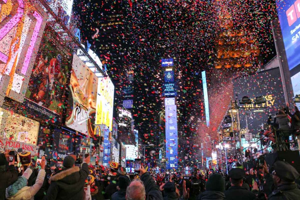 New York City, Times Square filled with confetti and crowds celebrating New Year’s Eve at night