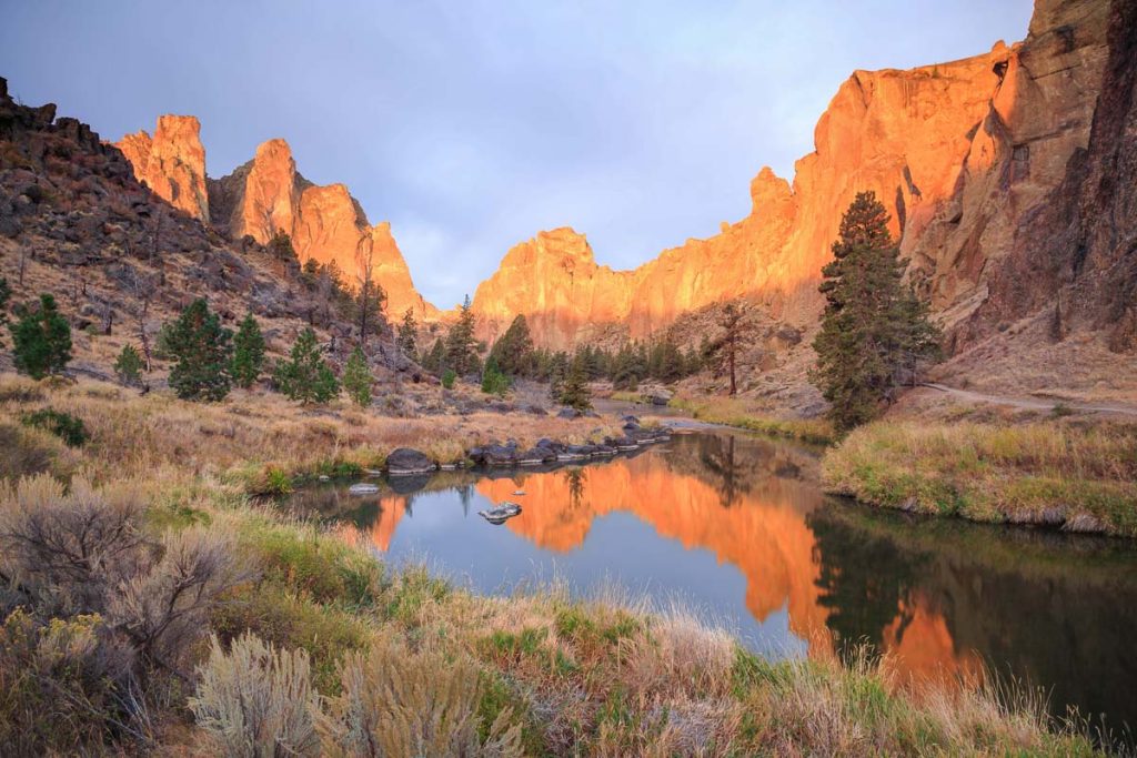 Smith Rock State Park, Central Oregon, USA. Sunrise light reflecting off canyon cliffs and the Crooked River