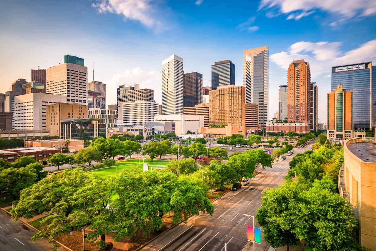 Texas, Houston, downtown skyline overlooking Root Square with modern skyscrapers and green parkland