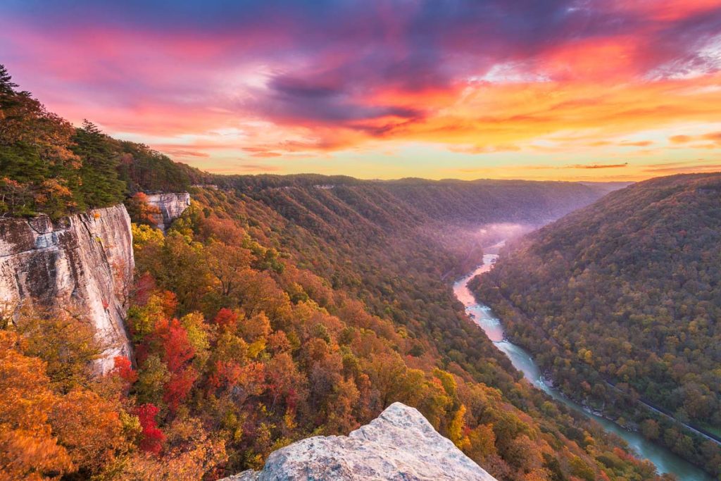West Virginia, New River Gorge, autumn morning view from the Endless Wall overlooking the winding river and colorful forested cliffs