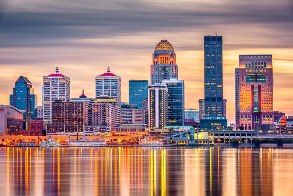 Louisville, Kentucky, USA downtown skyline on the Ohio River at dusk.