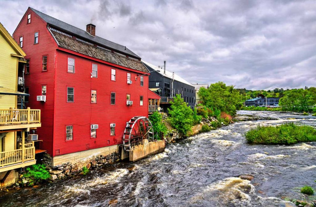New Hampshire, Littleton Grist Mill red historic mill with waterwheel on the Ammonoosuc River