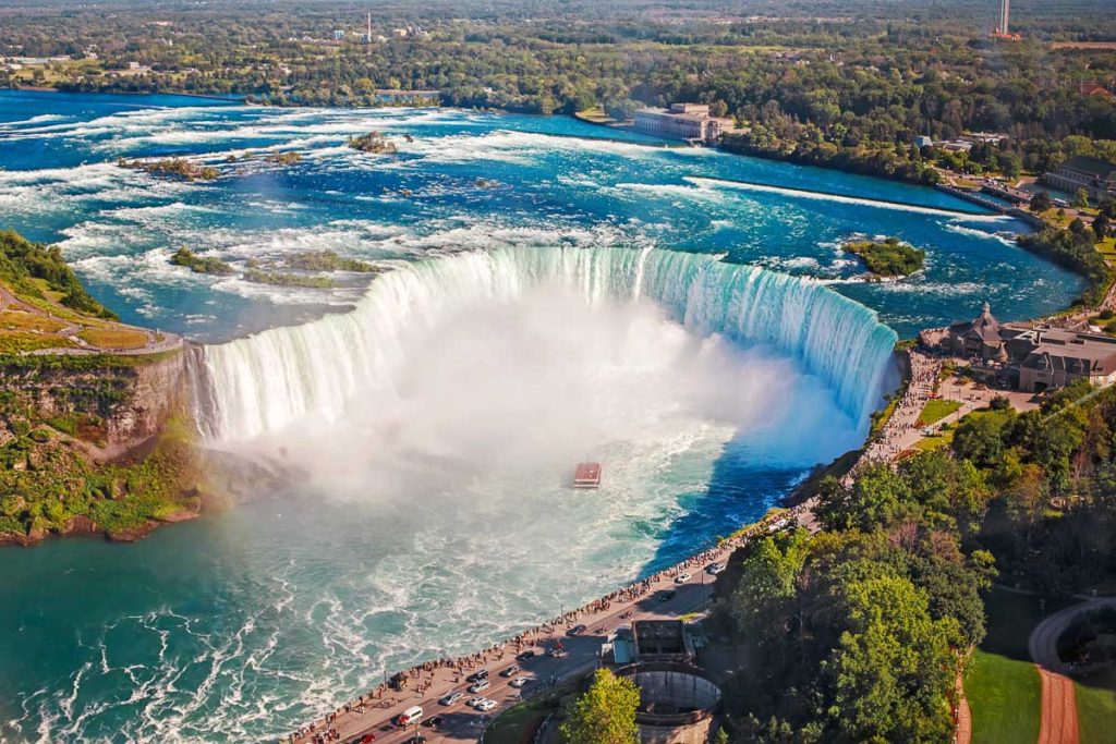 New York, Niagara Falls aerial view with tour boat in the river gorge