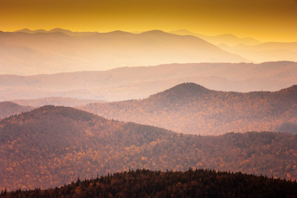 Blue hazy mountain range the fall in the New England town of Stowe Vermont, USA